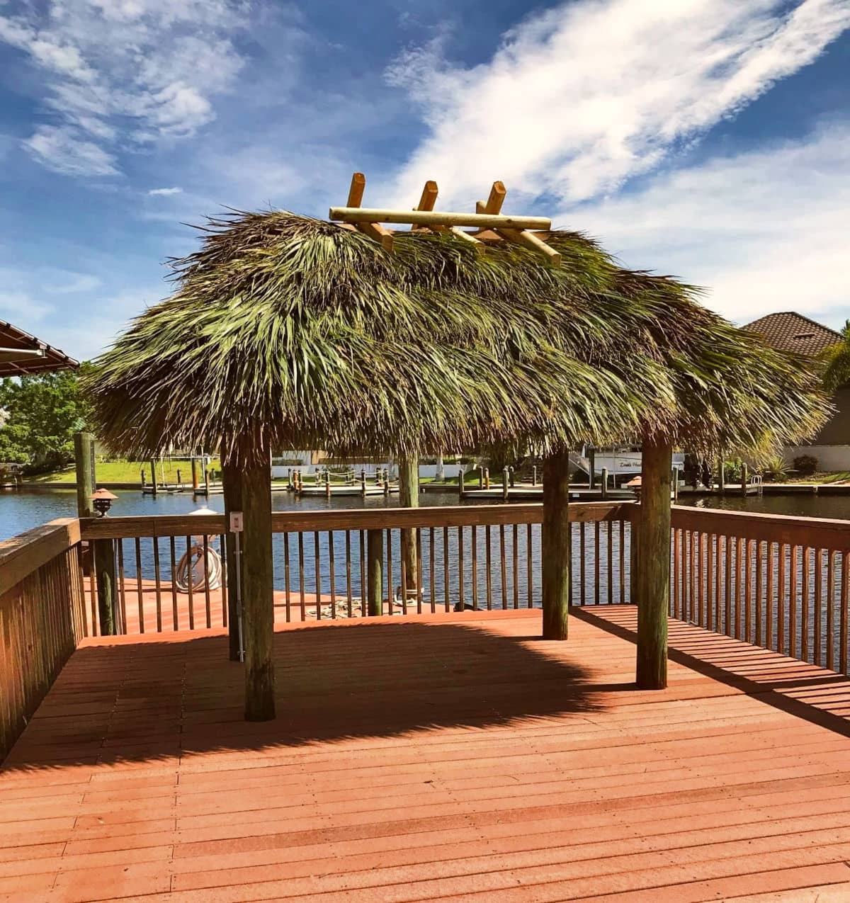 Small tiki built on a dock over the water.